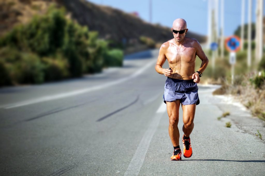 man running beside street